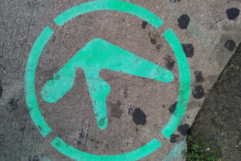 Aphex Twin's logo as street art on a sidewalk in New York City | Photo by Autopilot (CC by 4.0)