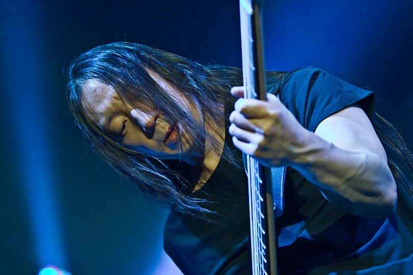 John Myung from Dream Theater doesn’t pretend to play bass, he actually can do it | Photo: Markus Hillgärtner, CC-BY-SA-3.0