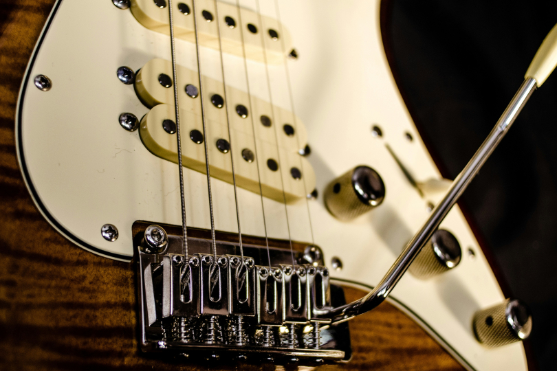 The guitar pickup is the "magical" place where the vibrations of the strings are transformed into an electrical signal, which is then sent to your amp: Dominik Scythe on Unsplash