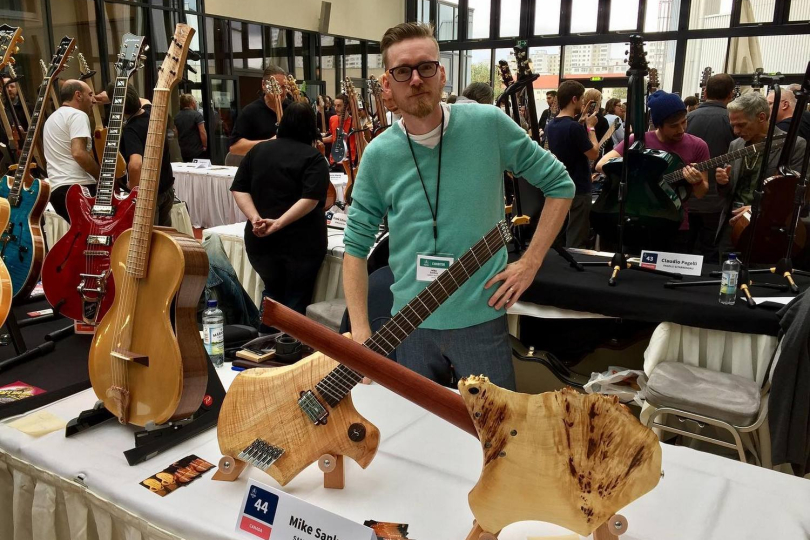 Mike Sankey with his work at the fair. | Photo: Sankey Guitars Facebook