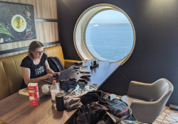 Loes works on a tour report on the boat from Dover to Dunkirk | Photo: Honza Bartošek